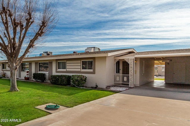 single story home featuring a carport and a front lawn