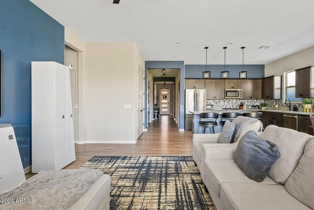 5725 S 101st St, Mesa, AZ 85212 - living room featuring baseboards and light wood-style floors