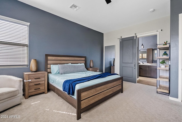 5725 S 101st St, Mesa, AZ 85212 - bedroom featuring a barn door, light carpet, ceiling fan, and visible vents