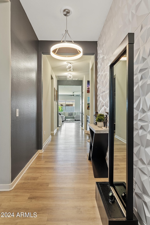 corridor with light hardwood / wood-style floors