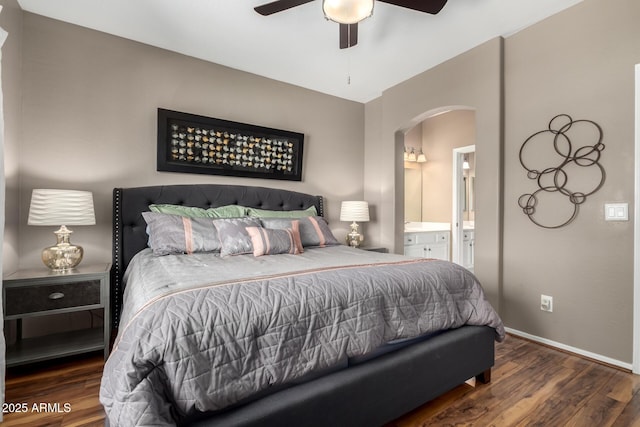 16626 E Westby Dr Unit 108, Fountain Hills, AZ 85268 - bedroom with arched walkways, wood finished floors, baseboards, and connected bathroom
