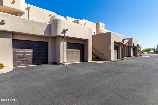 16626 E Westby Dr Unit 108, Fountain Hills, AZ 85268 - view of side of property featuring stucco siding and community garages
