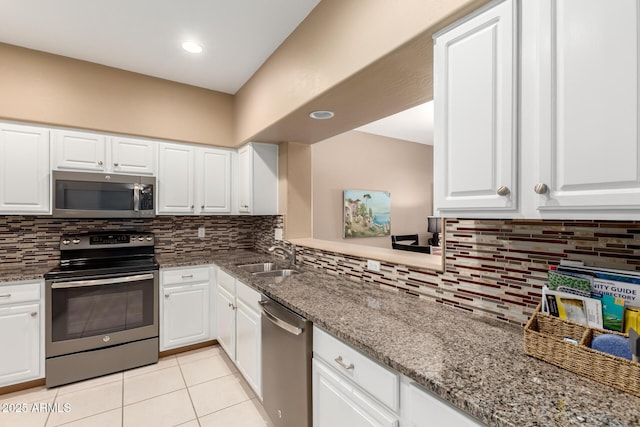 16626 E Westby Dr Unit 108, Fountain Hills, AZ 85268 - kitchen featuring appliances with stainless steel finishes, a sink, light tile patterned flooring, tasteful backsplash, and white cabinets