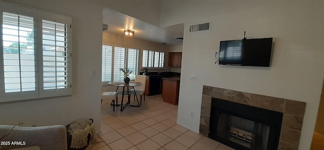 living area featuring light tile patterned floors and a tile fireplace