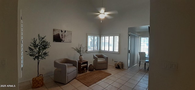 sitting room with a ceiling fan, light tile patterned floors, and baseboards