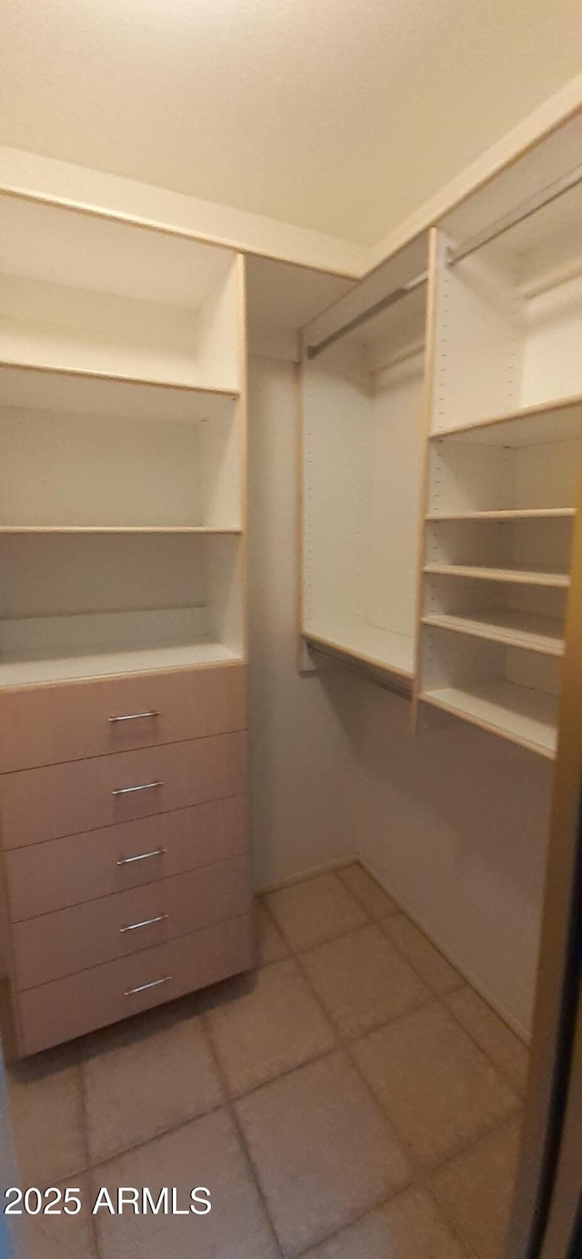 walk in closet featuring tile patterned flooring