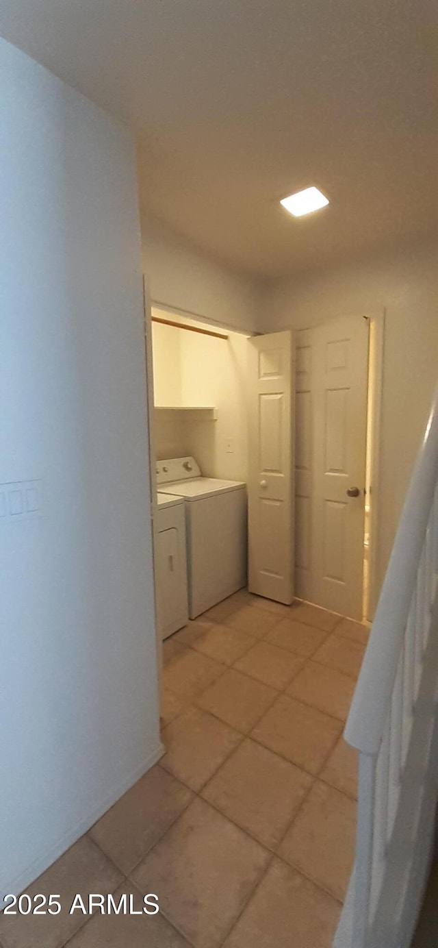 washroom with separate washer and dryer and light tile patterned floors