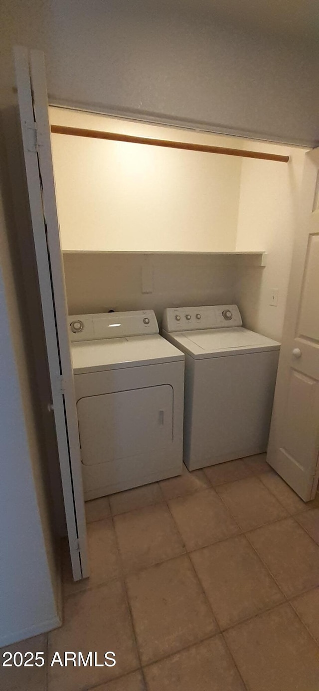 washroom featuring separate washer and dryer and light tile patterned flooring