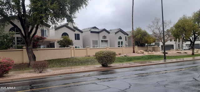 view of front facade featuring stucco siding and a residential view