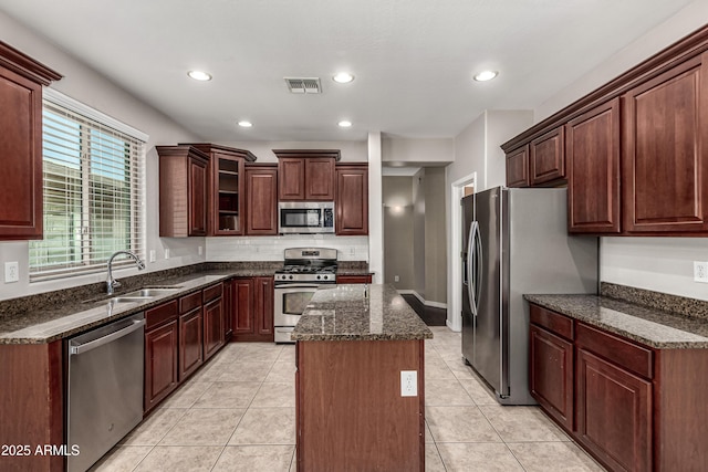 4322 S Ranger Trl, Gilbert, AZ 85297 - kitchen featuring stainless steel appliances, a kitchen island, dark stone counters, recessed lighting, and light tile patterned floors