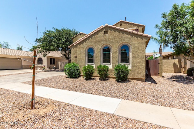 4322 S Ranger Trl, Gilbert, AZ 85297 - mediterranean / spanish home with a gate, a tile roof, stucco siding, and concrete driveway