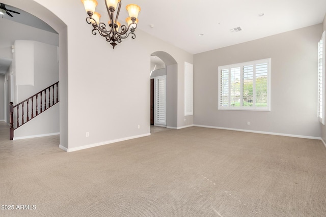 31604 N 19th Ave, Phoenix, AZ 85085 - spare room featuring a notable chandelier, baseboards, light carpet, visible vents, and arched walkways