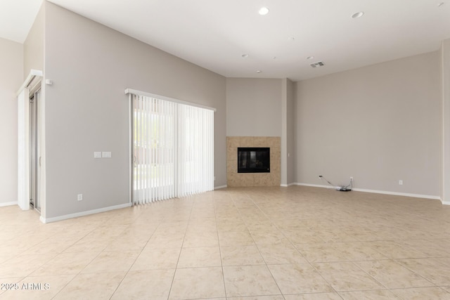 31604 N 19th Ave, Phoenix, AZ 85085 - unfurnished living room with visible vents, light tile patterned floors, baseboards, recessed lighting, and a tile fireplace