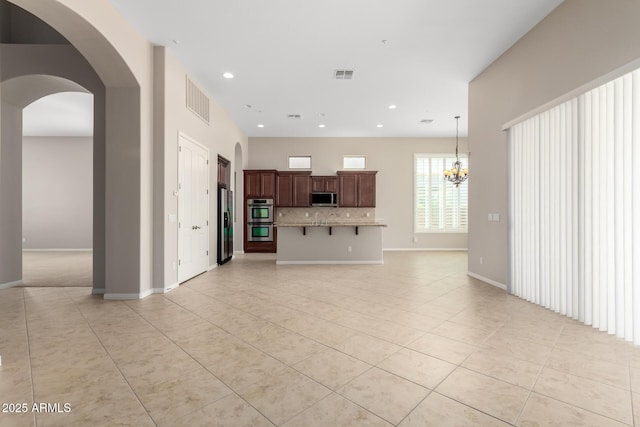31604 N 19th Ave, Phoenix, AZ 85085 - unfurnished living room with light tile patterned floors, visible vents, and baseboards