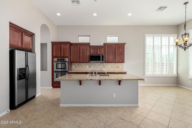 31604 N 19th Ave, Phoenix, AZ 85085 - kitchen with a sink, an island with sink, light stone countertops, backsplash, and stainless steel appliances