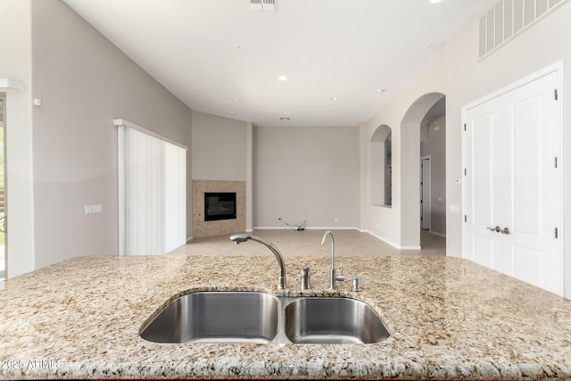 31604 N 19th Ave, Phoenix, AZ 85085 - kitchen with a sink, visible vents, light stone counters, and a fireplace