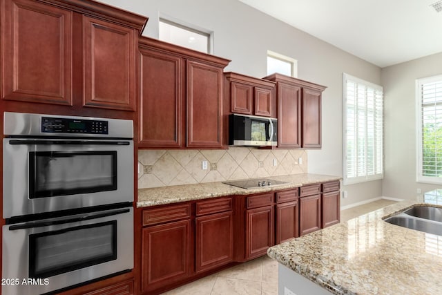 31604 N 19th Ave, Phoenix, AZ 85085 - kitchen featuring appliances with stainless steel finishes, light stone countertops, visible vents, decorative backsplash, and a sink
