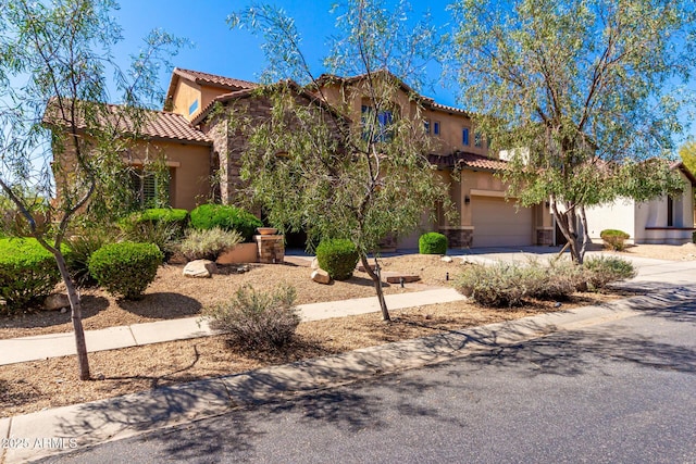 31604 N 19th Ave, Phoenix, AZ 85085 - mediterranean / spanish house featuring stucco siding, driveway, stone siding, an attached garage, and a tiled roof