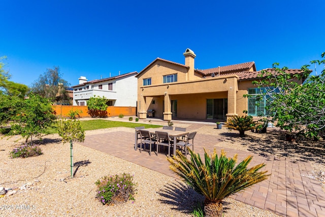 31604 N 19th Ave, Phoenix, AZ 85085 - back of house with a patio area, a tiled roof, a chimney, fence, and stucco siding