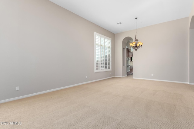 31604 N 19th Ave, Phoenix, AZ 85085 - unfurnished room with arched walkways, a notable chandelier, light colored carpet, and baseboards