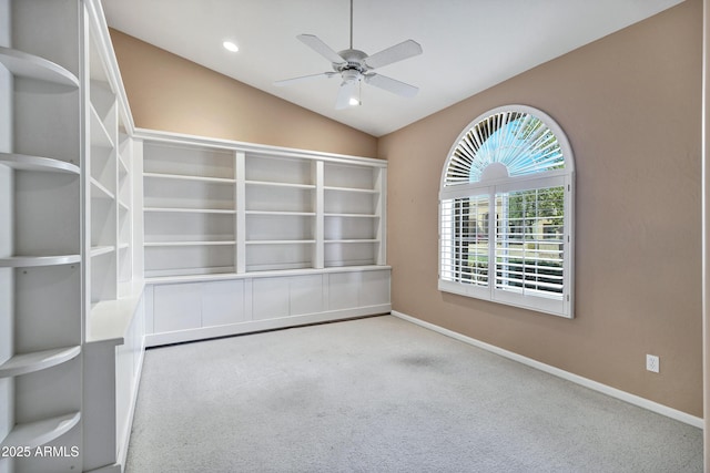 unfurnished room featuring ceiling fan, carpet flooring, and lofted ceiling