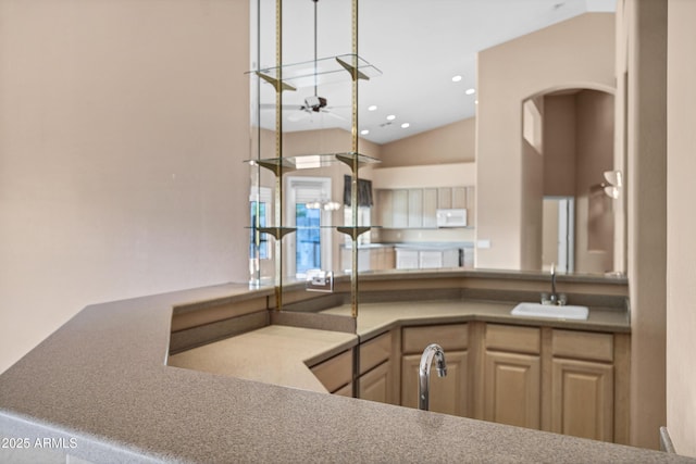 kitchen with sink, ceiling fan, lofted ceiling, and light brown cabinets