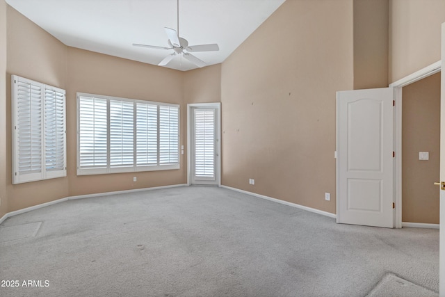 carpeted spare room with vaulted ceiling and ceiling fan