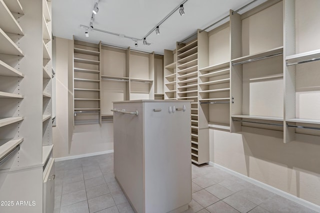 spacious closet with light tile patterned floors