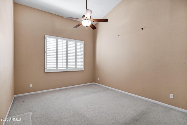 carpeted spare room featuring ceiling fan