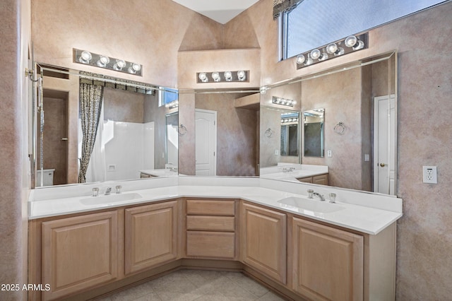 bathroom featuring walk in shower, tile patterned flooring, high vaulted ceiling, and vanity