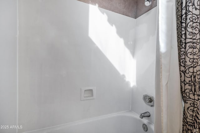 bathroom with shower / bath combination with curtain