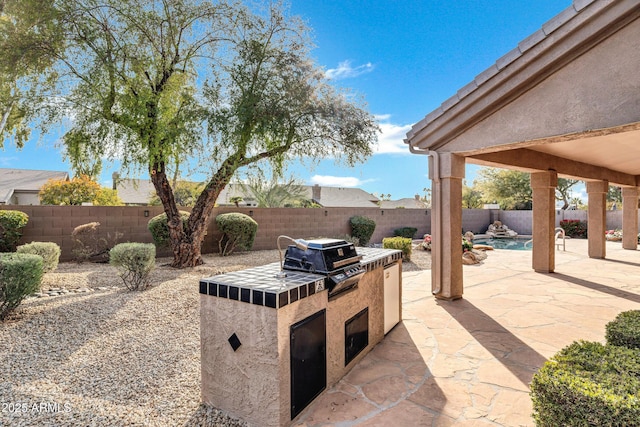 view of patio / terrace featuring area for grilling and exterior kitchen