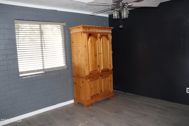 spare room with dark hardwood / wood-style flooring and ceiling fan