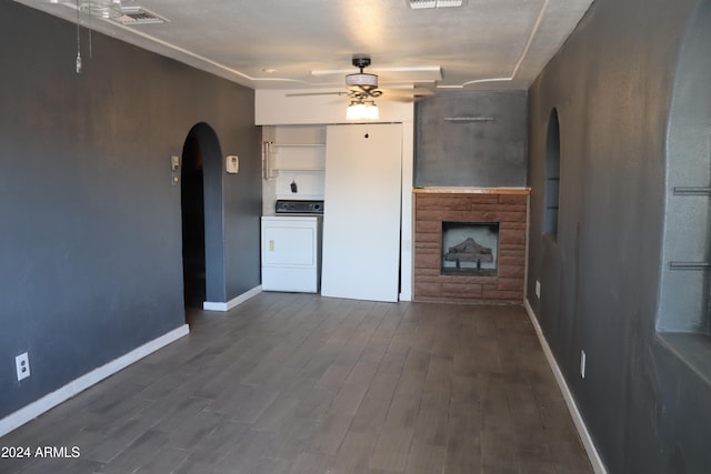 unfurnished living room featuring washing machine and clothes dryer, ceiling fan, and hardwood / wood-style floors