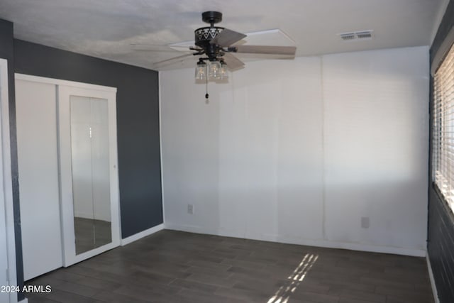 spare room featuring dark hardwood / wood-style floors and ceiling fan