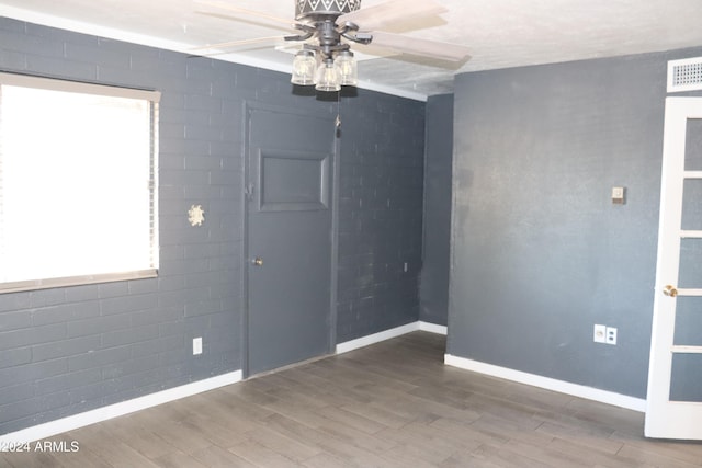 spare room with wood-type flooring and ceiling fan