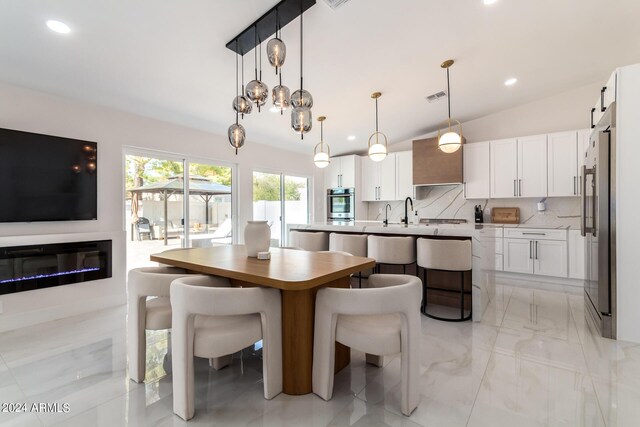 interior space with light tile patterned floors and lofted ceiling