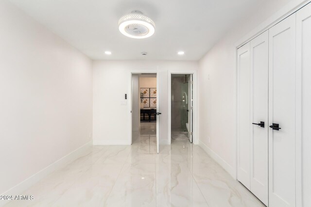 hall with light tile patterned floors