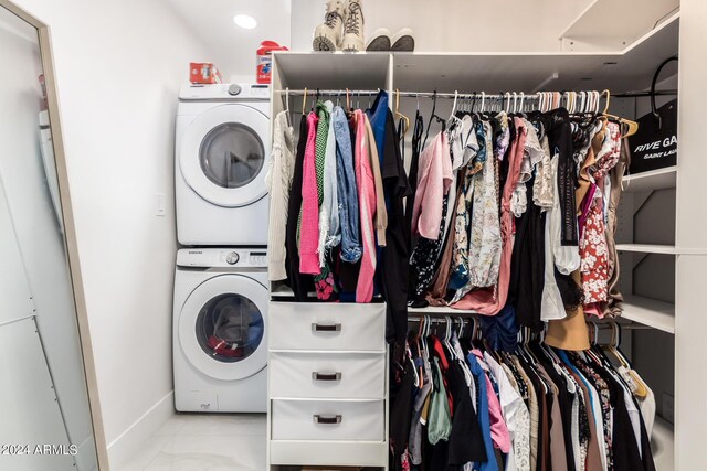 laundry area featuring stacked washer / dryer