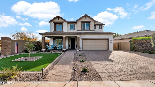 craftsman-style house featuring covered porch, a front yard, and a garage