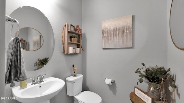 bathroom featuring sink and toilet