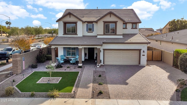 view of front of property featuring a garage and a front lawn