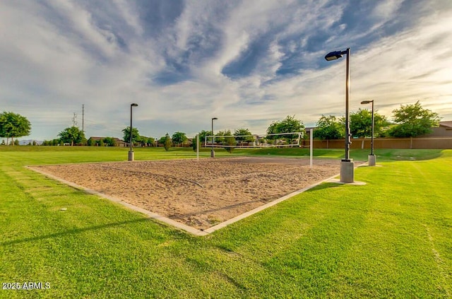 view of home's community with volleyball court and a yard