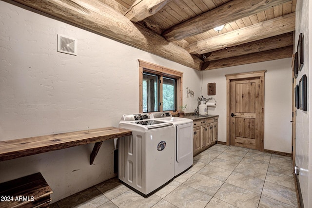 washroom with light tile patterned floors, cabinet space, wooden ceiling, and separate washer and dryer