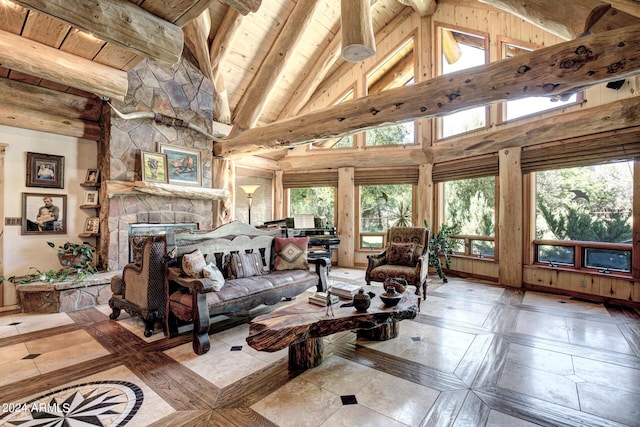 living area featuring wood ceiling, beamed ceiling, a fireplace, and high vaulted ceiling