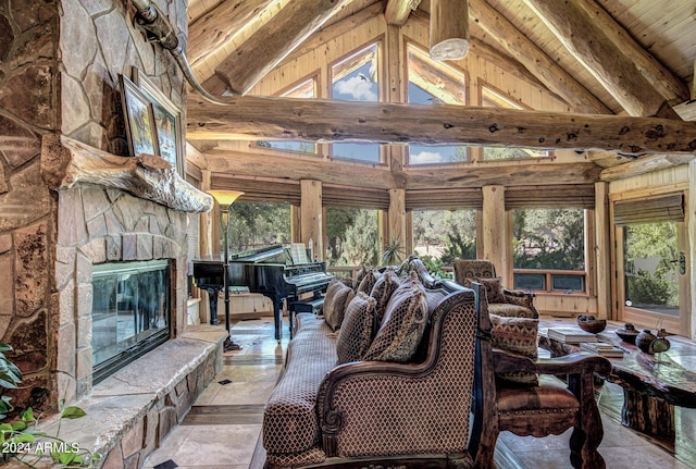 living area featuring beamed ceiling, high vaulted ceiling, wooden ceiling, and a fireplace