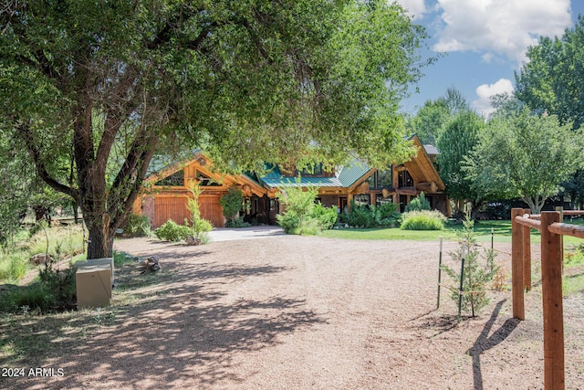 view of front of home featuring driveway, metal roof, and a standing seam roof