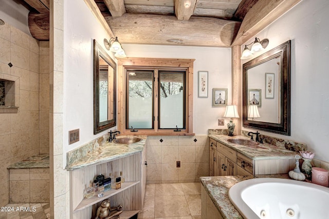 full bathroom with beam ceiling, a tub with jets, tile walls, and a sink