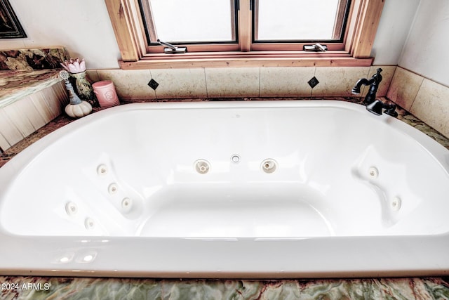 full bathroom featuring a whirlpool tub