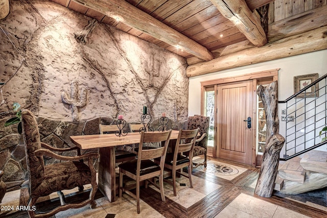 dining space featuring beamed ceiling, wooden ceiling, and stairway